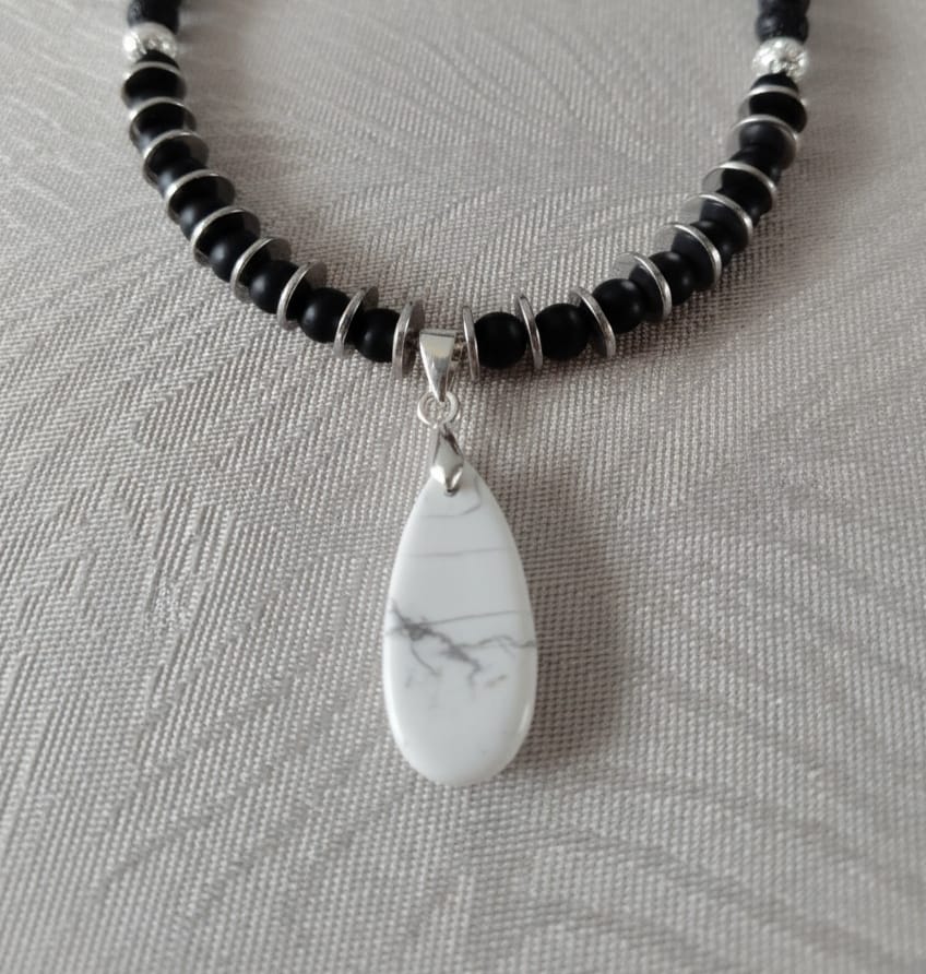 "Natural stone necklace featuring volcanic beads, silver hematite and white howlite pendant"