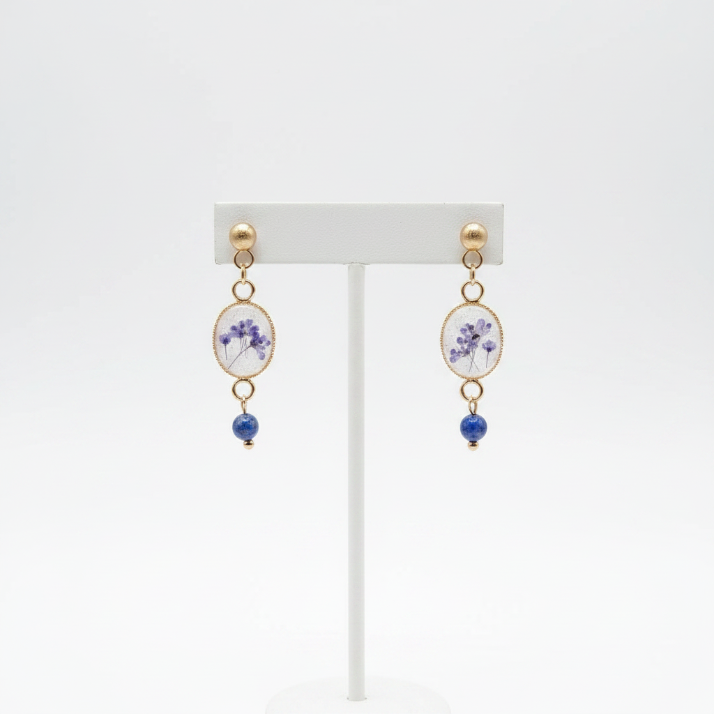 Violet lapis lazuli drop earrings on stand, white background