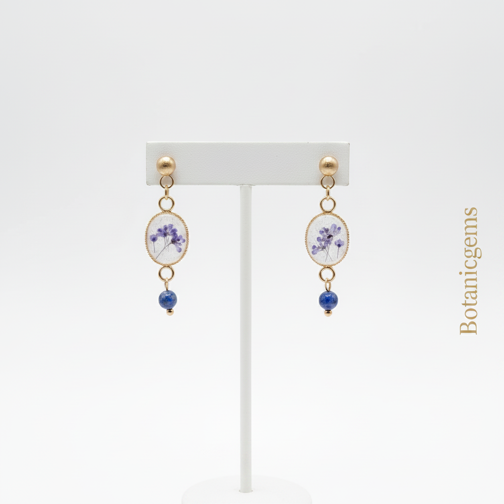 Violet lapis lazuli drop earrings on stand, white background