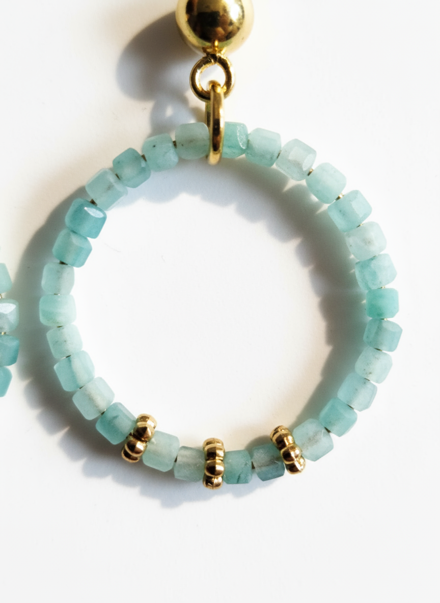 Close-up of square aquamarine beads - 2mm gemstone detail with gold spacers"