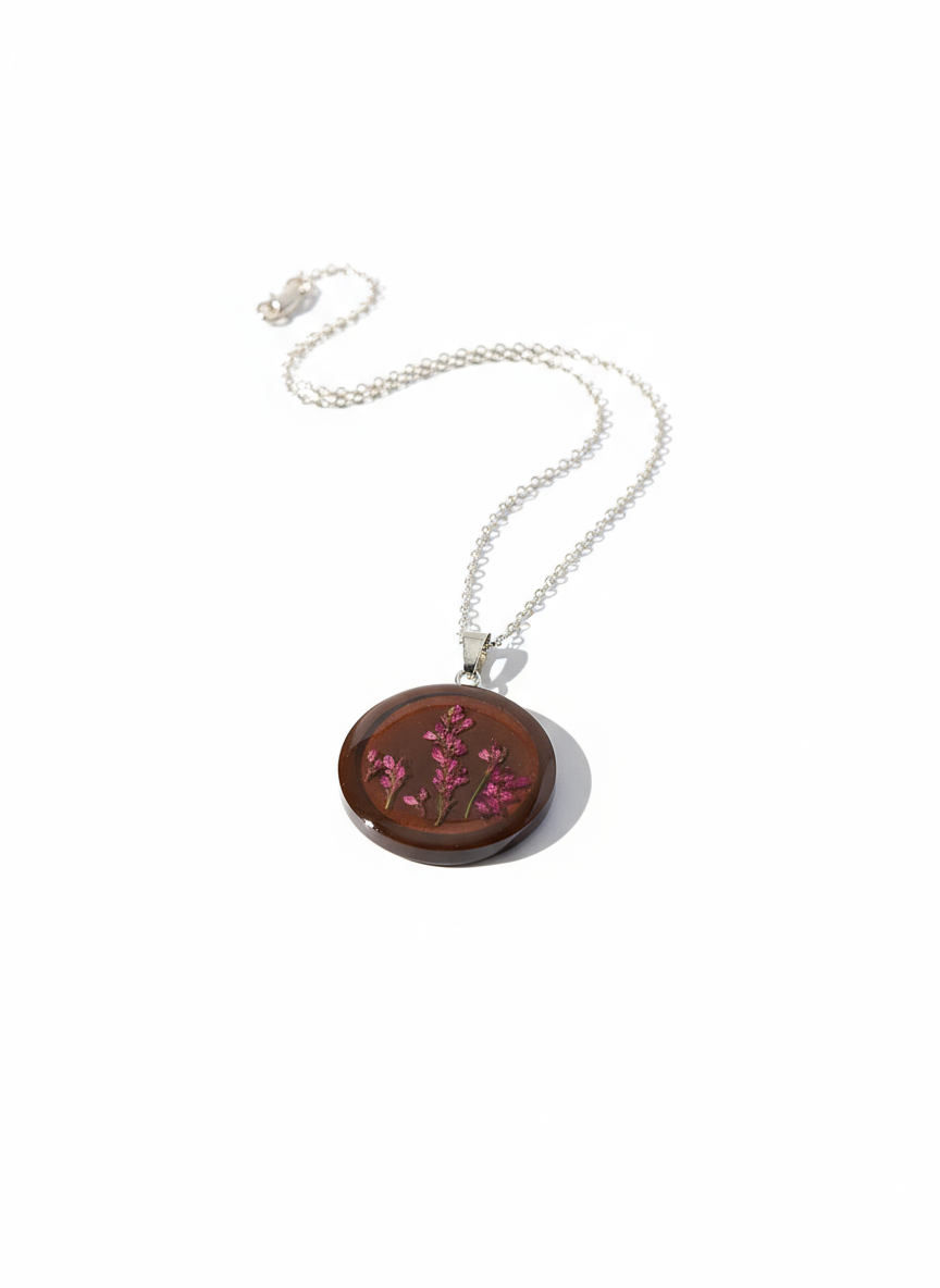 "Dark brown resin round pendant necklace with pressed pink heather flowers and silver chain"