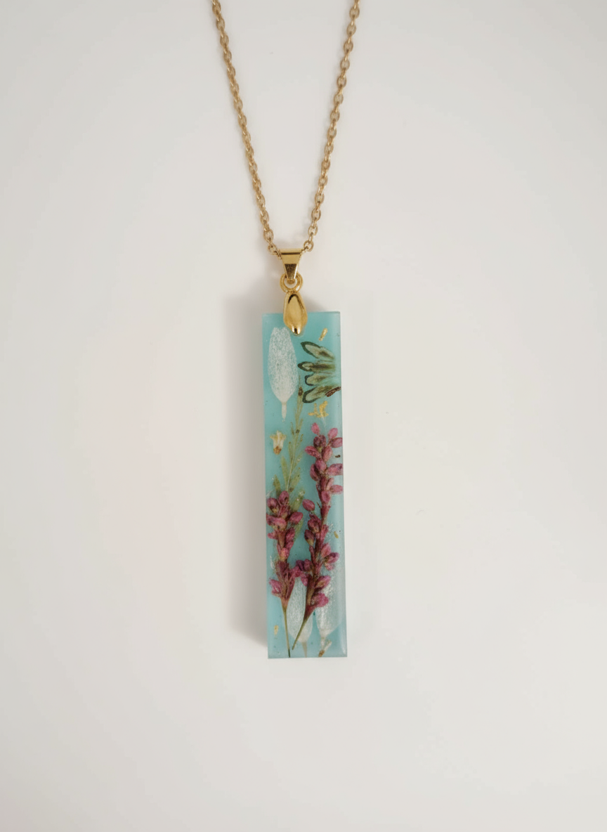 Turquoise blue rectangular pendant necklace with pressed pink heather flowers and gold chain"