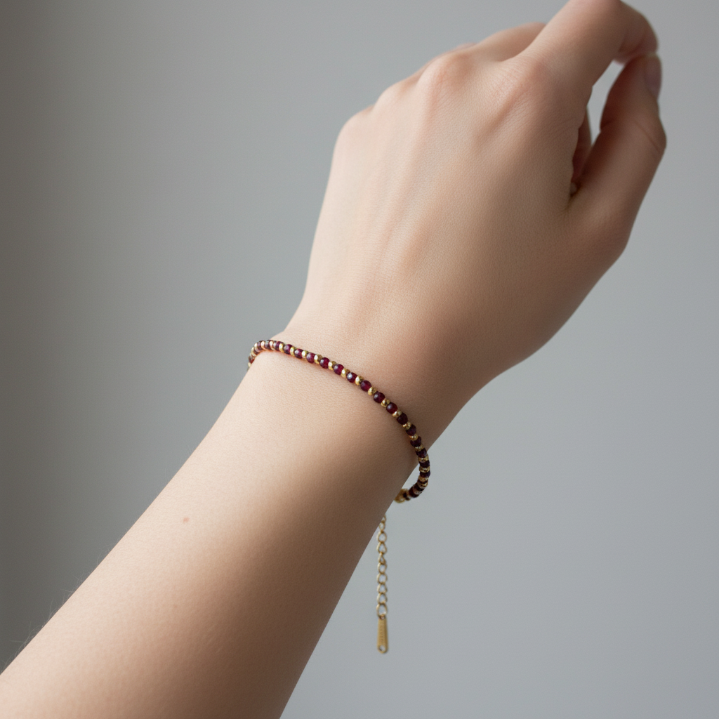 Woman wearing deep red garnet gemstone bracelet on wrist lifestyle photo