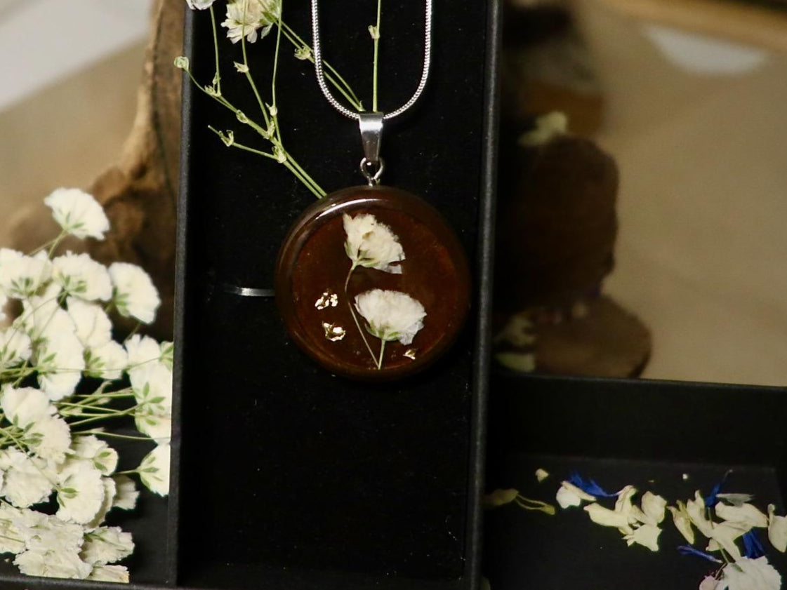 Close-up of delicate dried Gypsophila (baby's breath) flowers preserved in clear resin, handmade by Botanic Gems Jewelry
