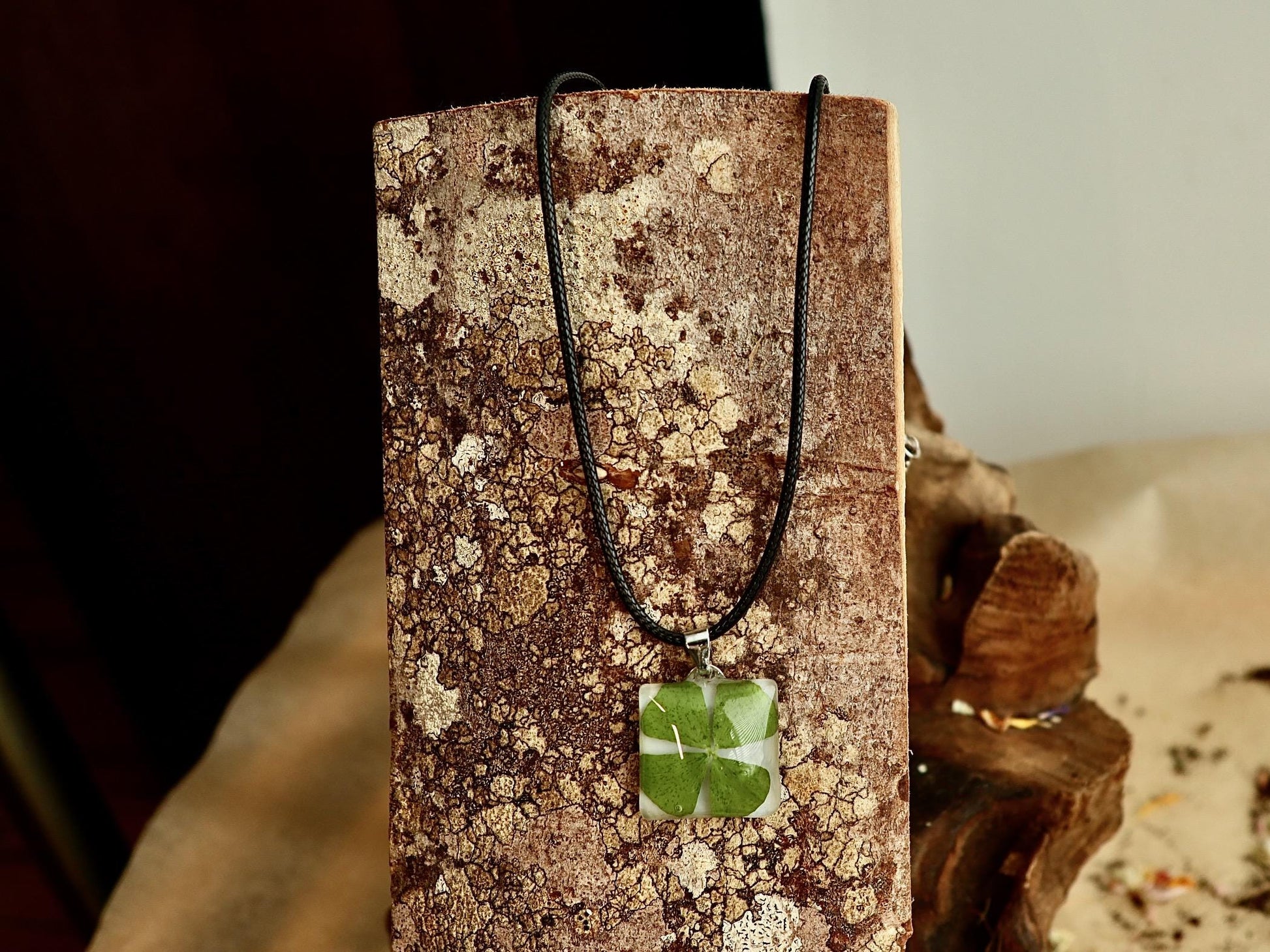 Handmade Irish four-leaf clover necklace worn, displaying its elegant drape and charm as a good luck keepsake
