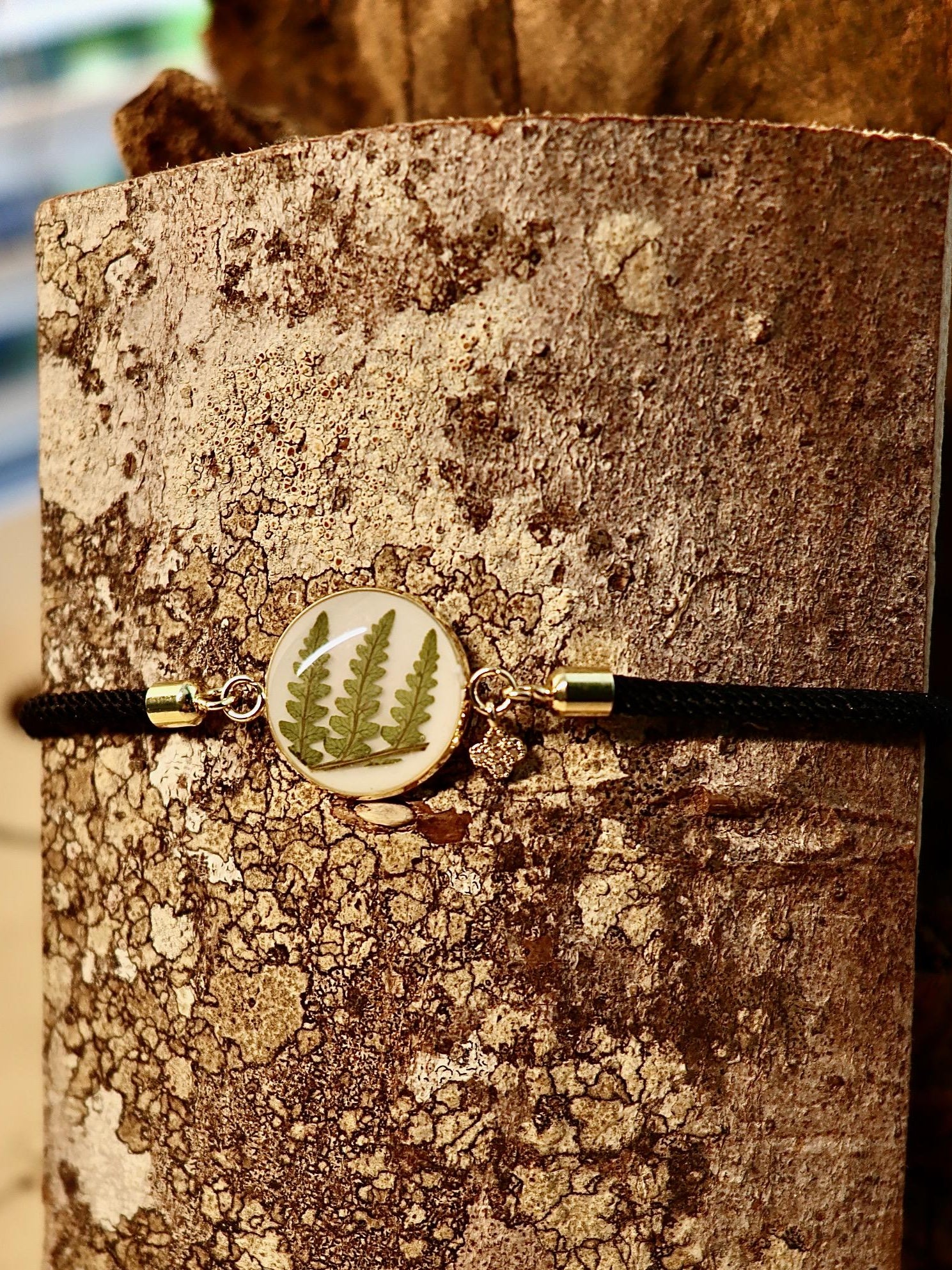 Handmade bracelet with real Irish ferns worn on a wrist, showcasing elegant fit and natural style