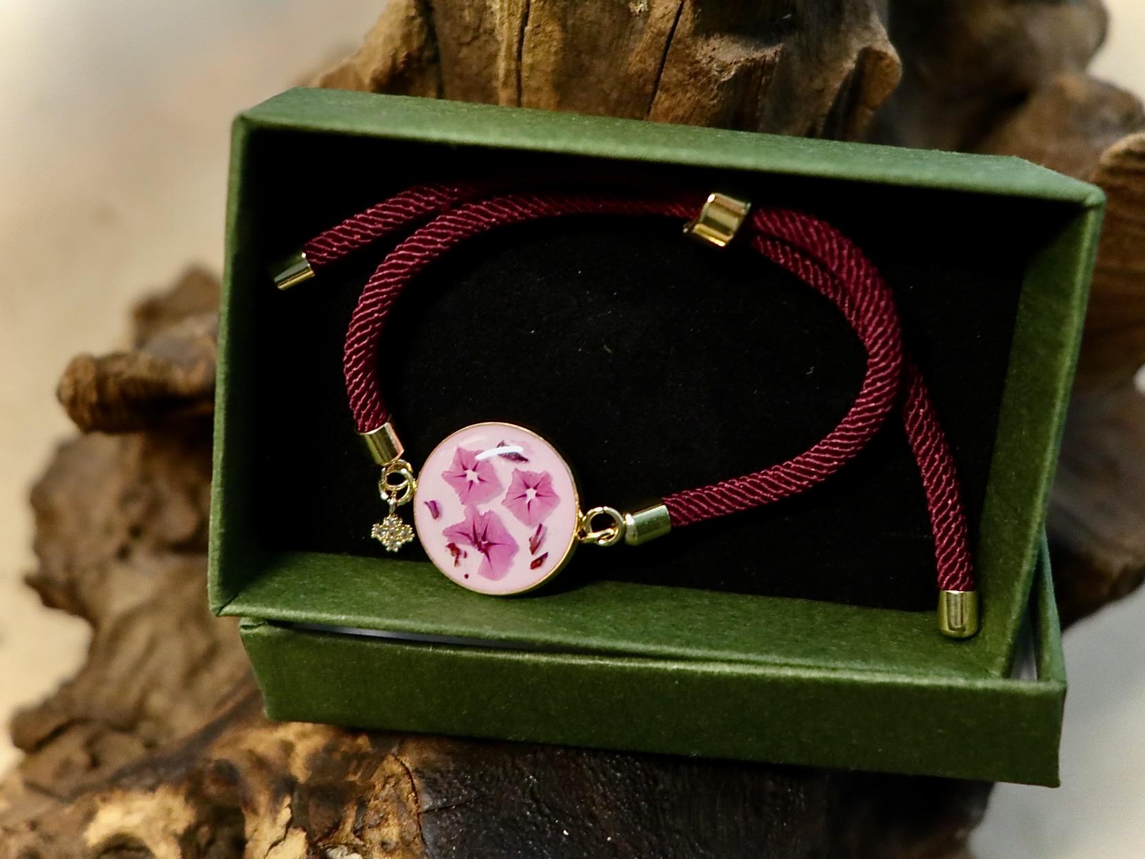 Handmade real pink Limonium flower jewelry displayed with Botanic Gems Jewelry branded packaging