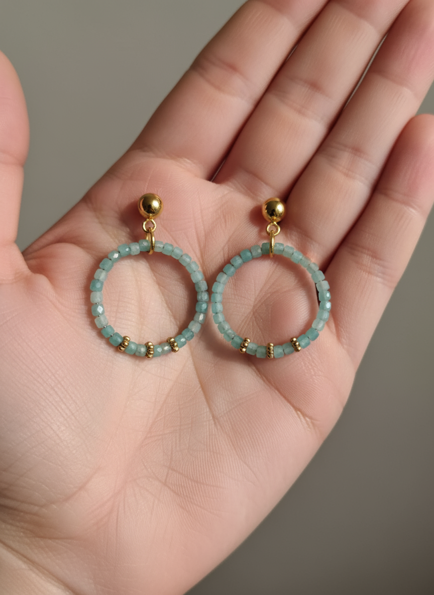 Aquamarine hoop earrings in hand - handcrafted beaded circle earrings with gold accents"