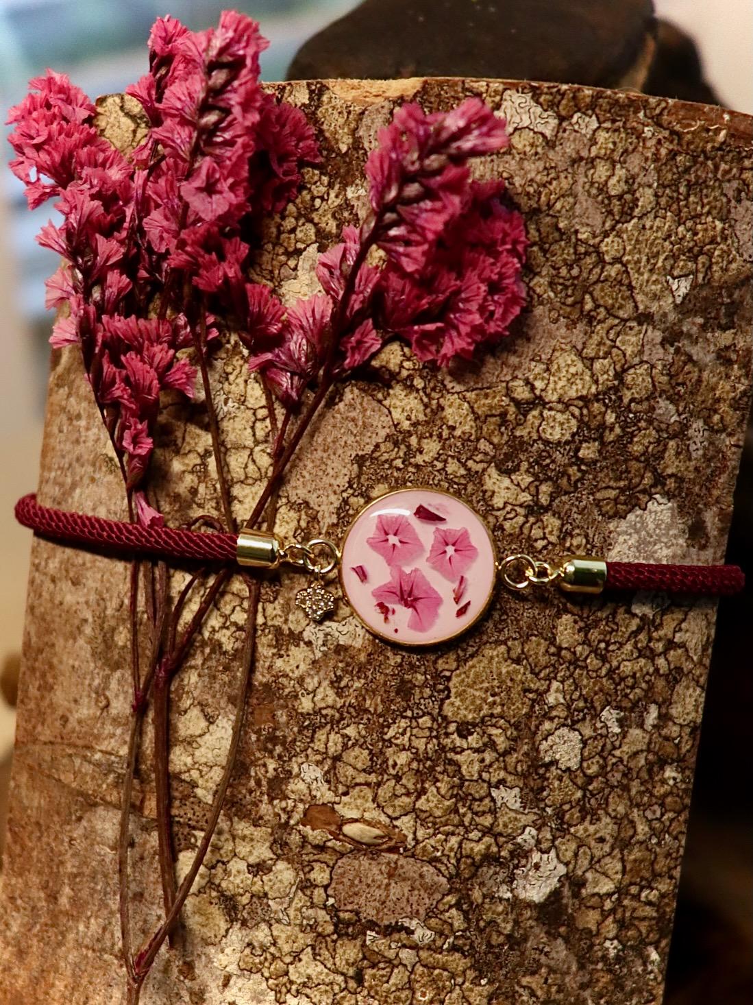 Close-up of delicate pink Limonium flowers preserved in clear resin, handmade by Botanic Gems Jewelry