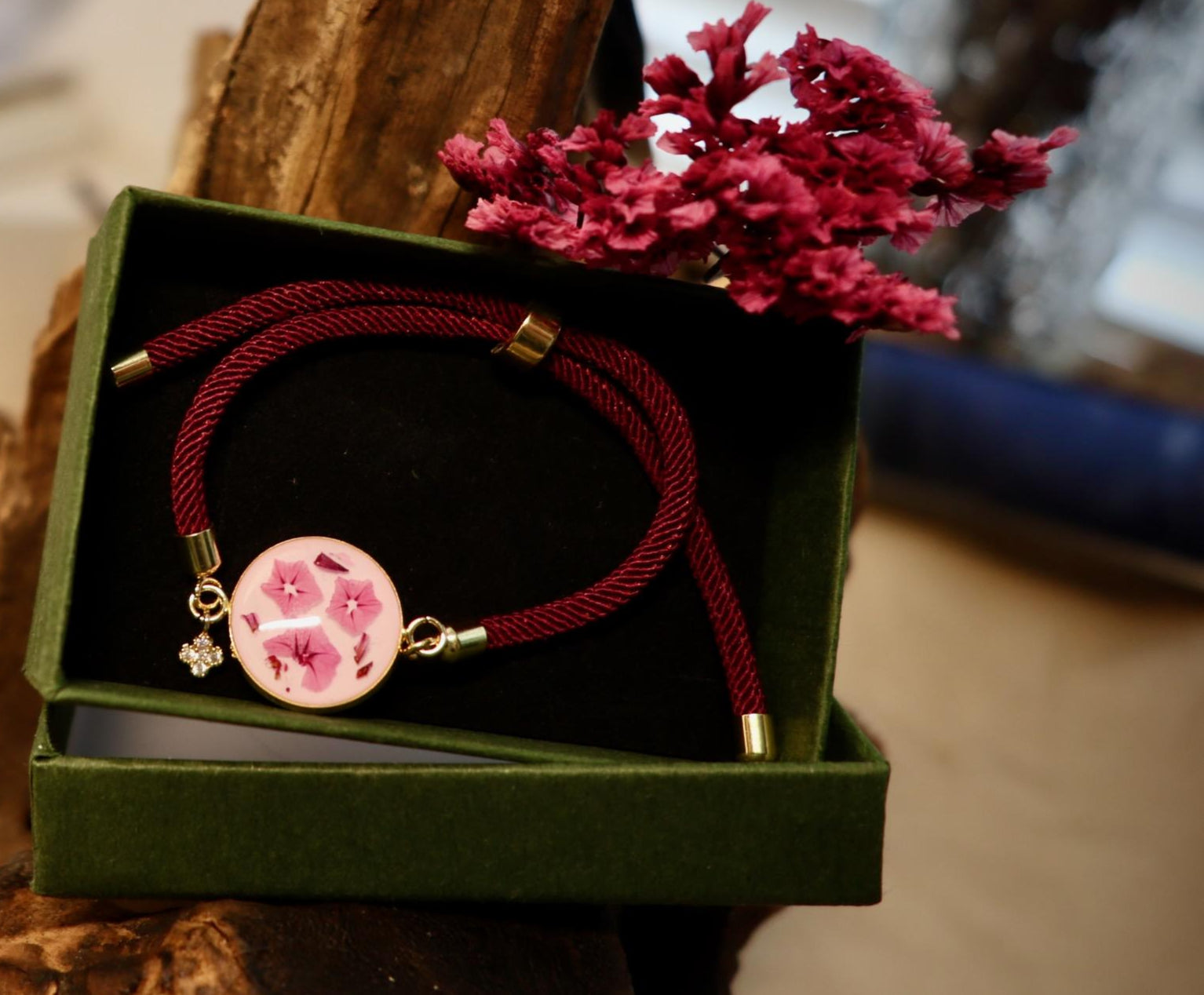 Real pink Limonium flower jewelry worn on model, showcasing elegant botanical style from Botanic Gems Jewelry.
