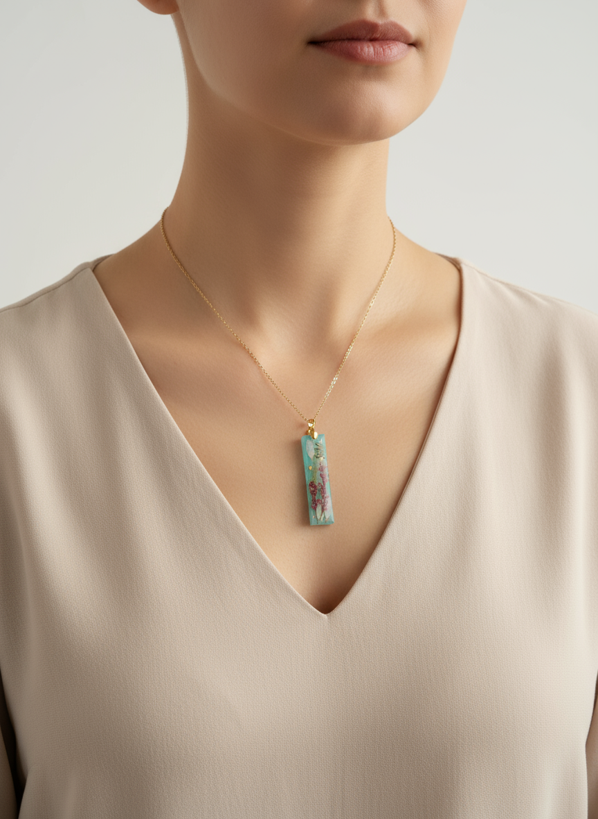 Woman wearing turquoise blue pressed flower pendant necklace on neck lifestyle photo"