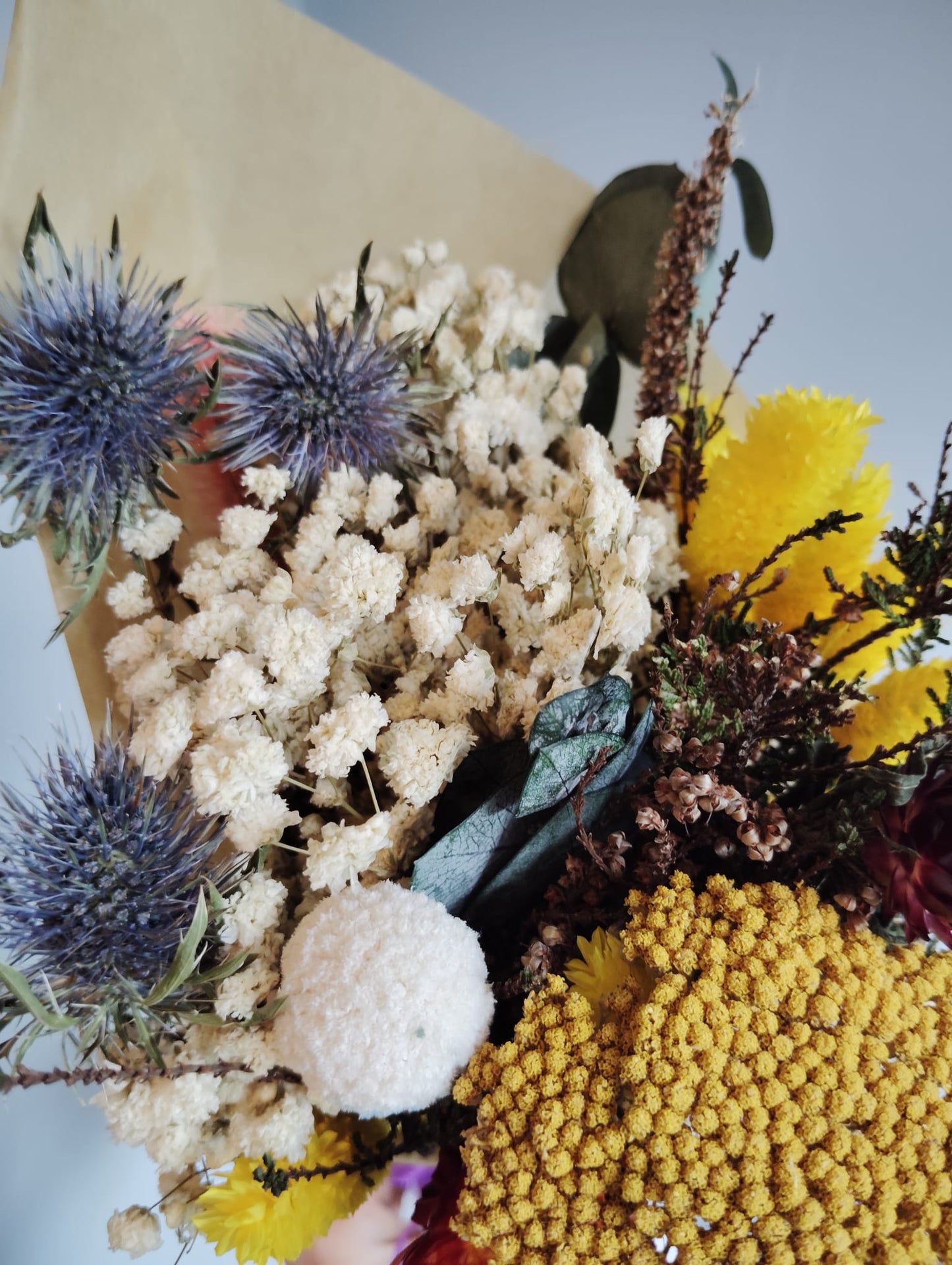 High-quality preserved flower bouquet with sunny yellow tones and textured blue thistles for a farmhouse look